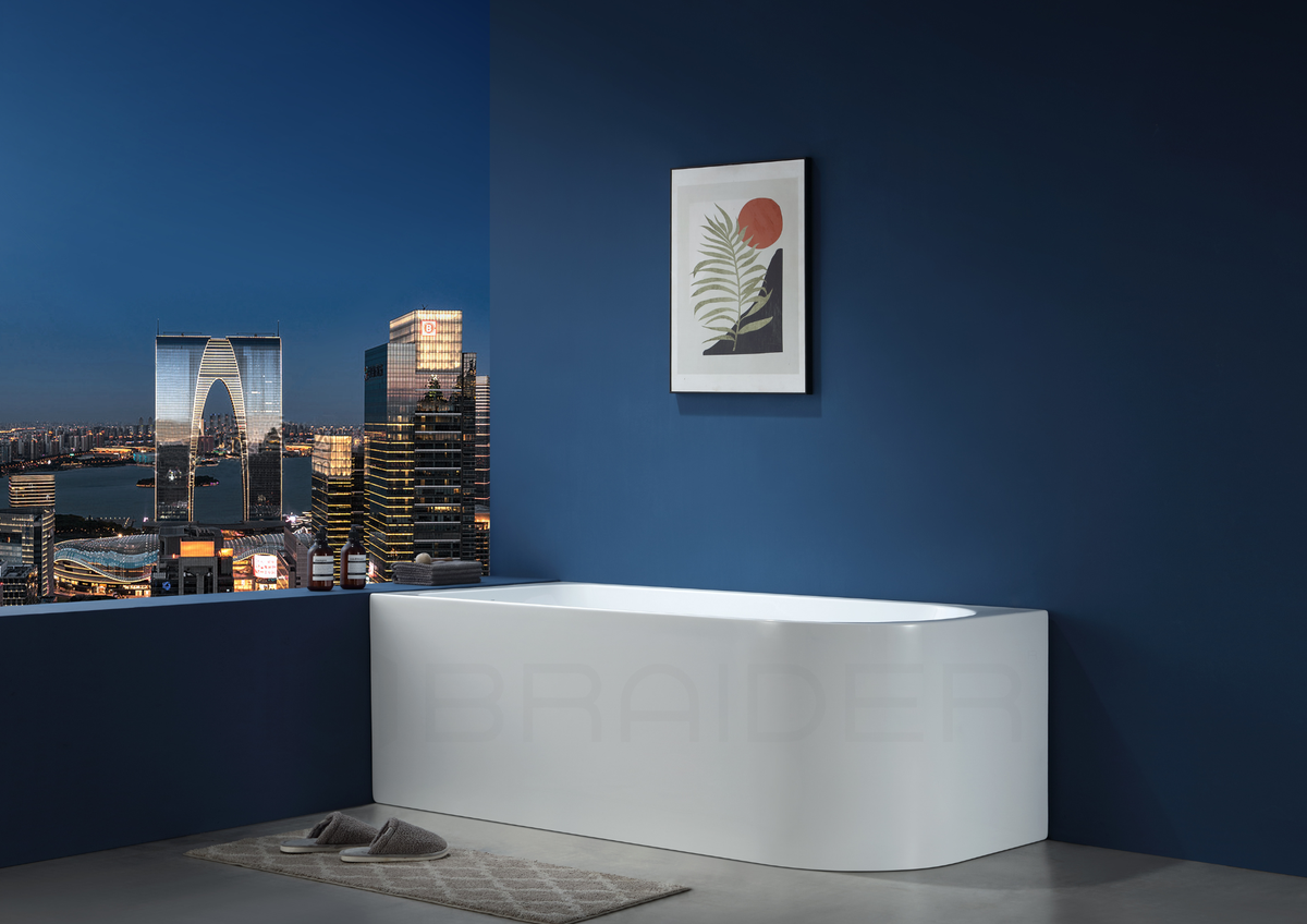 A modern freestanding white bathtub in a bathroom setting. Corner bath, J Shaped 